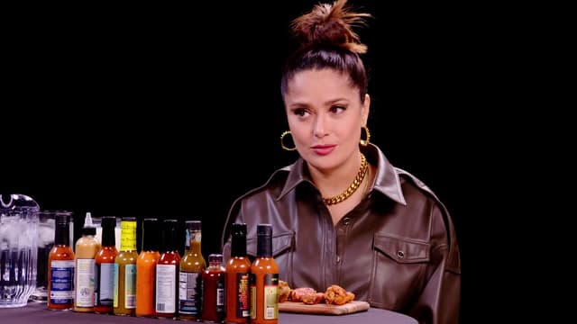 S16:E07 - Salma Hayek Adopts Sean Evans While Eating Spicy Wings