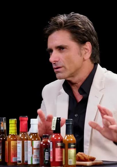 S21:E09 - John Stamos Falls Out of His Chair While Eating Spicy Wings poster