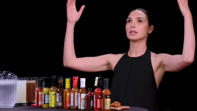 S21:E12 - Gal Gadot Does a Spit Take While Eating Spicy Wings