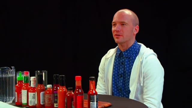 S03:E23 - Superfan Brett Baker Grills Sean Evans Over Spicy Wings